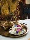 Exposition in the Museum of the Cossacks - Samovar faucet and cup and saucer on a tray - attributes of a traditional tea ceremony.