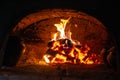 Village stove firewood and fire. Burning wood inside traditional oven