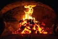 Village stove firewood and fire. Burning wood inside traditional oven