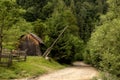 village street in green mountains. old wooden barn along the road