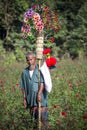 A village street hawker Kohinur age 68, selling colorful paper flowers, Dhaka, Bangladesh.