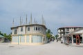 Village street with local buildings,road, bikes and people during sunny day located at the tropical island Maamigili