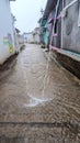 village street in rain flowing water on street