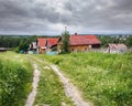 Village street in summer. Traditional wooden country houses. Village of Visim, Russia Royalty Free Stock Photo