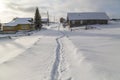 The village street is swept by snow.