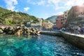 The village of Vernazza Italy as tourists line it`s harbor and wait to board tourist boats.