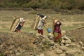 Village in the vicinity of Pokhara. Peasant women carry firewood