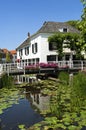 Village view with canal, water, colorful flowers Royalty Free Stock Photo