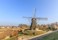 Village view with original village houses and wind mill in polder landscape