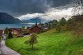 Village Weggis on Lucerne lake under dramatic clouds, Switzerland