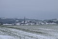 village Welling with the dark church tower during winter snow