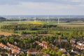 Village and wind turbines in flat landscape Royalty Free Stock Photo