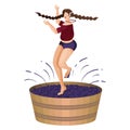 Village young woman is crushing grapes with her feet while dancing in large wooden vat