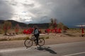 villager on a bicycle traveling on a road in front of a place of popular veneration in the Province of Jujuy