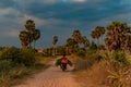 Villager on bike on Cambodian dirt road