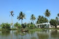 A villager rows a traditional boat in the backwaters