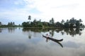 A villager rows a traditional boat in the backwaters