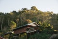 Villager`s house with trees and mountain in the background in the Akha village of Maejantai on the hill in Chiang Mai, Thailand Royalty Free Stock Photo