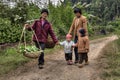 Villagers in China, women with children, are on country road.