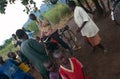 Villagers listening to pedal-powered radio, Uganda