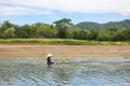 Villagers are searching for fish at Land with dry and cracked ground because dryness global warming Royalty Free Stock Photo