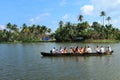 Villagers travel in a traditional boat in the backwaters