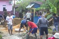 Villagers work together to repair damaged village footpaths.