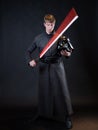 A villain with a red lightsaber, a young man in a long robe does fighting poses, Royalty Free Stock Photo