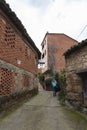 An alley with old stone and red brick buildings in the town of Villanueva de la Vera in Caceres, Extremadura Royalty Free Stock Photo