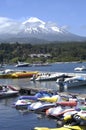 active volcanoes in Chile, seen from Pucon.with boat marina with luxurious architecture.may 2016