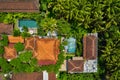 Villas with colorful shingle roofs and swimming pools between palm trees Royalty Free Stock Photo