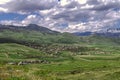 Blue skies over the village, from the cumulus clouds coming from the mountain range Azhdahak and snow-capped mountains of Geghama Royalty Free Stock Photo