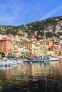Villefrance, France, seafront buildings and boats with reflections in water