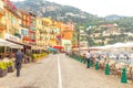 Villefranche-sur-Mer - Cote d`Azur, France June 24, 2018: view of seaside harbor and people at street terraces in colorful town Vi Royalty Free Stock Photo