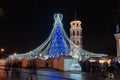 Vilnius Cathedral square with ornate decorated and illuminated Christmas tree at night