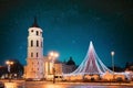 Vilnius, Lithuania. Amazing Bold Bright Blue Starry Sky Gradient Above Christmas Tree On Background Bell Tower Belfry Of Royalty Free Stock Photo