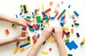 Vilnius, Lithuania - April, 2017. Children hands play with colorful lego blocks on white table. Royalty Free Stock Photo
