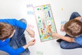 Vilnius, Lithuania - 23 April 2017: Children playing board game Monopoly Royalty Free Stock Photo