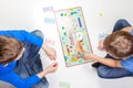 Vilnius, Lithuania - 23 April 2017: Children playing board game Monopoly