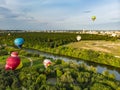 VILNIUS, LITHUANIA - AUGUST 12, 2018: Colorful hot air balloons flying over forests surrounding Vilnius city on summer evening Royalty Free Stock Photo