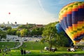 VILNIUS, LITHUANIA - AUGUST 15, 2018: Colorful hot air balloons taking off in Old town of Vilnius city on sunny summer evening Royalty Free Stock Photo