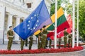 VILNIUS, LITHUANIA - AUGUST 22, 2018: Europ Union flag and Lithuanian flags rising up by Lithuanian soldiers in Daukantas square n