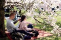 Vilnius, Lithuania - 04 22 2019: Boy brushing hair of his girlfriend at Sugihara park