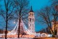 Vilnius, Lithuania. Christmas Tree On Background Bell Tower Belfry Of Vilnius Cathedral At Cathedral Square In Evening Royalty Free Stock Photo