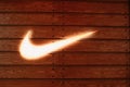 Vilnius Lithuania. Close Glowing Logotype Swoosh Of Nike Brand At Wooden Wall Of Store In Acropolis
