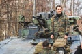 Armored crawler tank with cannon and female soldier smiling