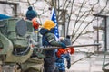 Kids or children playing like soldiers on the top of a tank or military vehicle with a machine gunan and Lithuanian flag