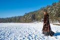 Girl drinking coffee or tea on the snow in winter Royalty Free Stock Photo