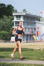 Beautiful blond girl in sport clothes running in the park