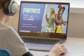 Vilnius, Lithuania - July 2, 2019: Boy playing Fortnite game. Fortnite is online video game developed by Epic Games